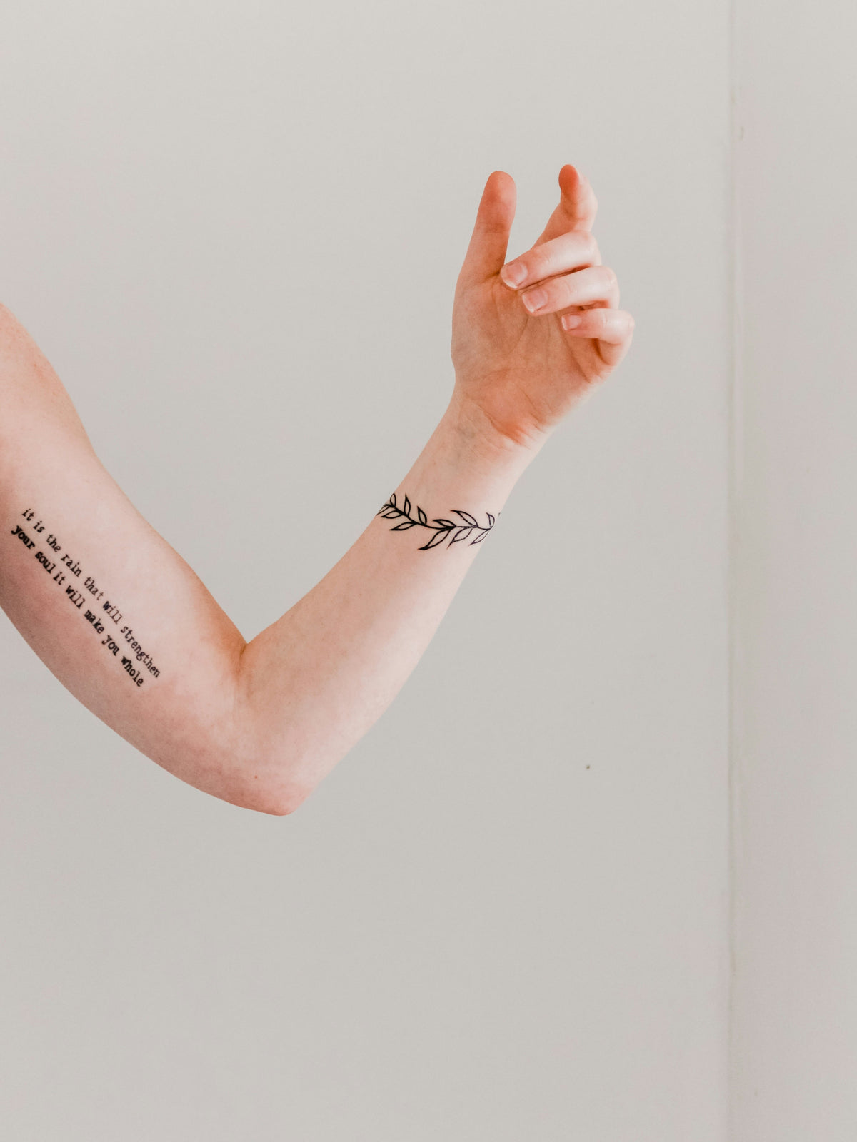 Woman's arm and wrist with small fine-line tattoos