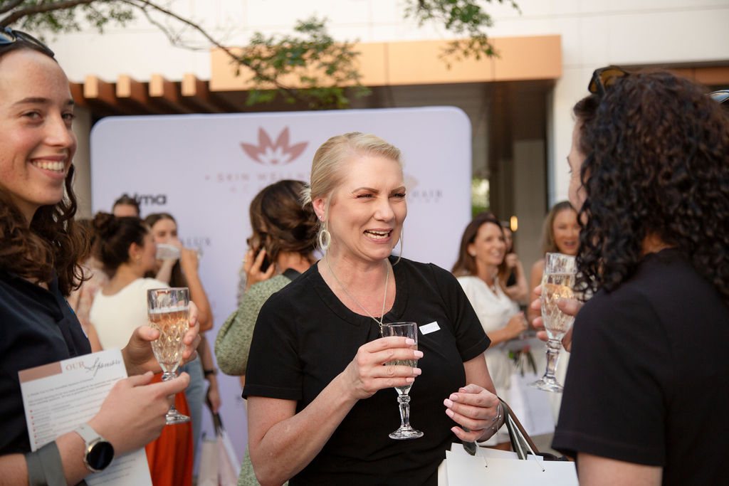 Guests holding glasses of sparkling wine and chatting at a previous SWA event