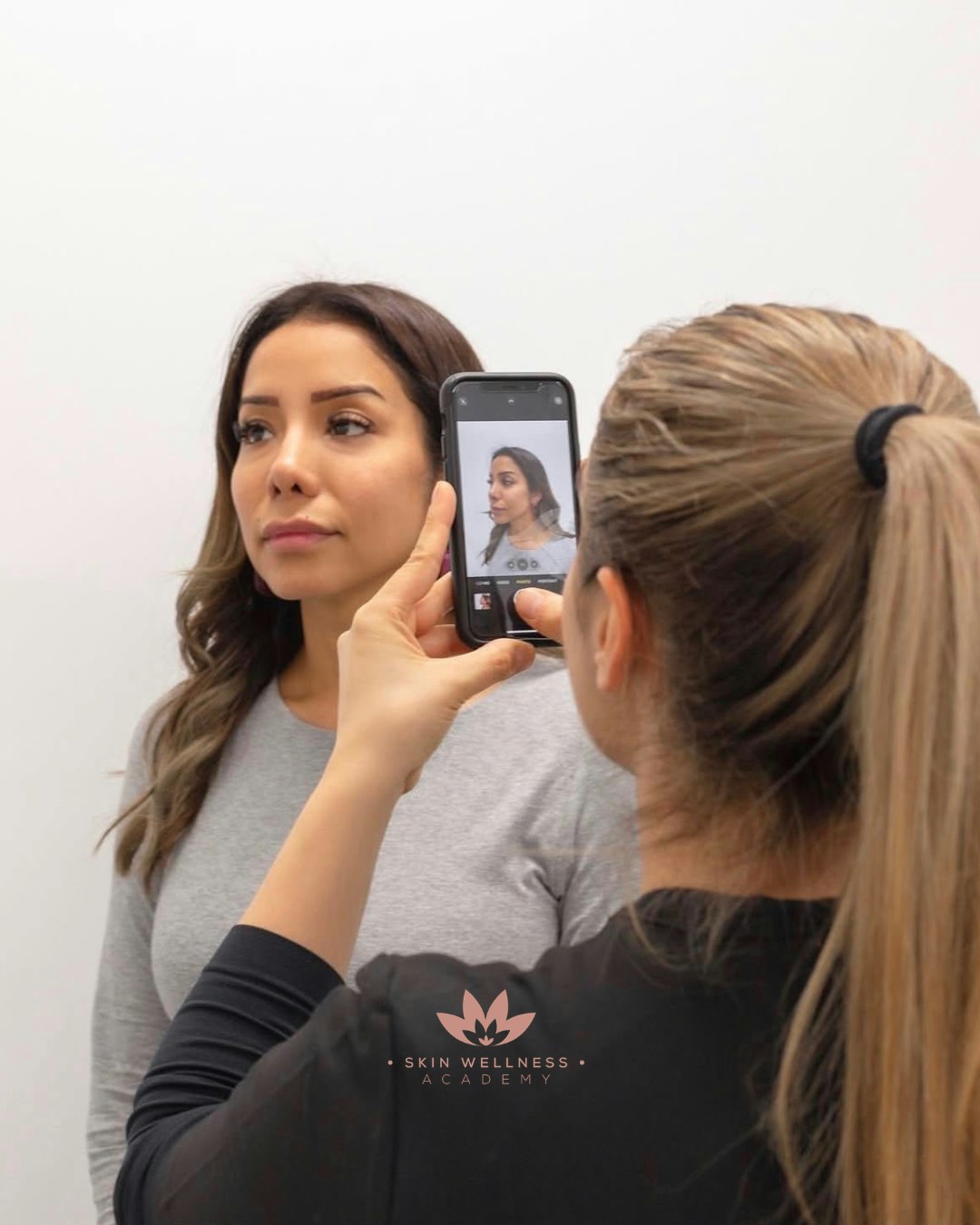 A clinician taking assessment photos of Tina Ashkani at Skin Wellness Academy