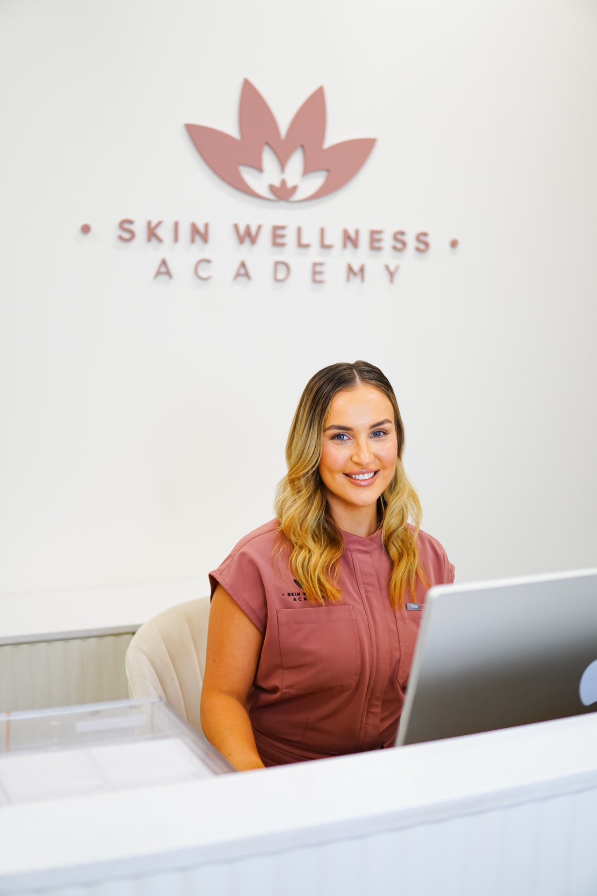 Kate, Front of House and Beauty Therapist, at the Skin Wellness Academy reception