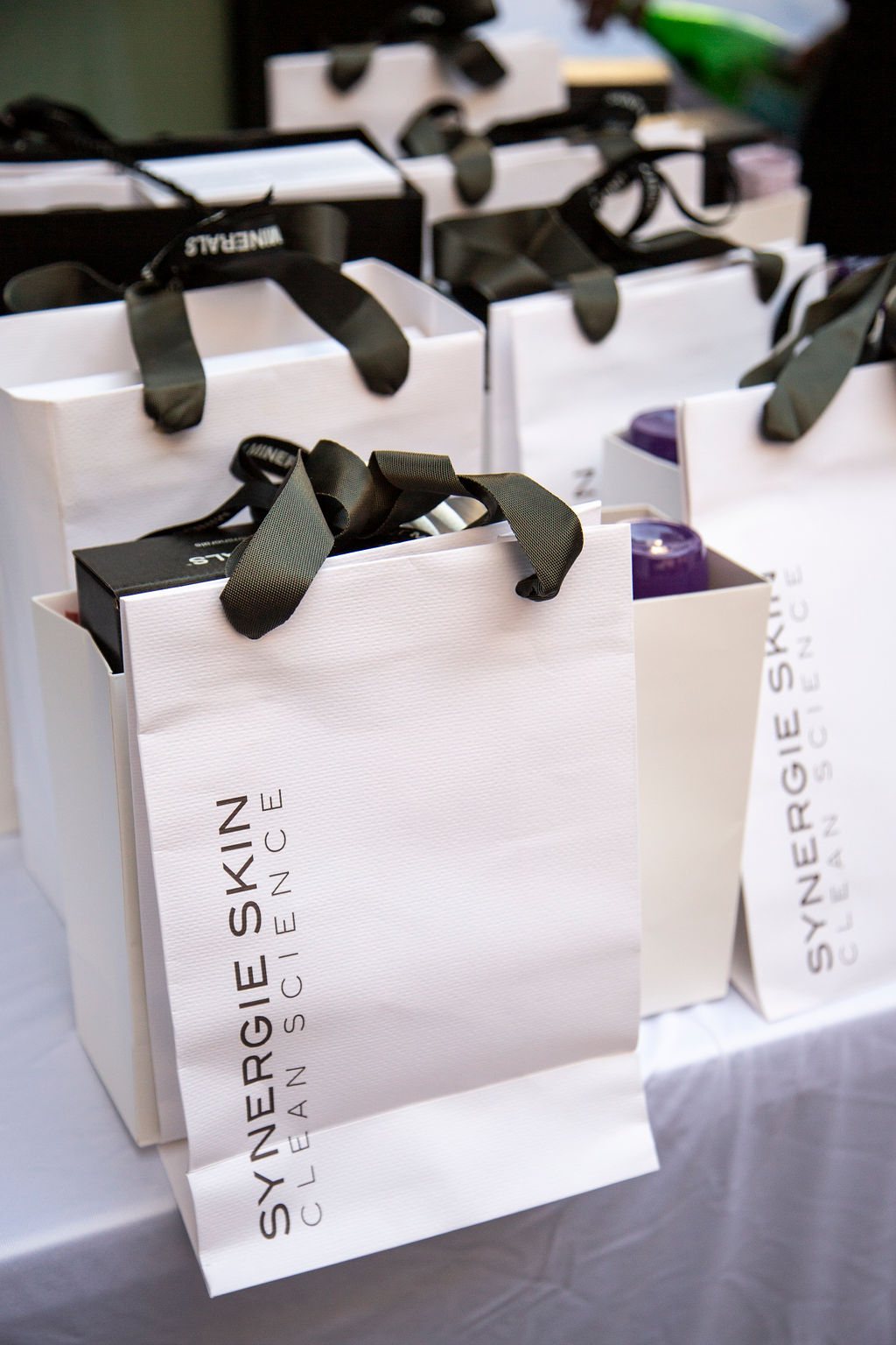 Branded gift bags lined up on a table at a previous SWA event