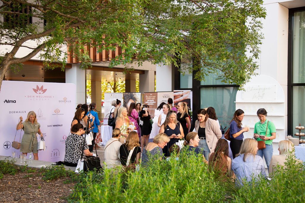 Guests gathering outdoors at a previous Skin Wellness Academy event